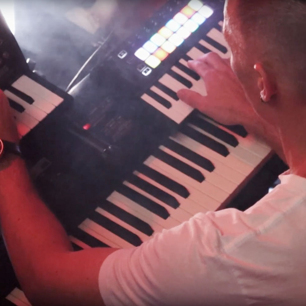 Still frame from performance film from Sessions at the Shangri-la. Taken from over Timothy's shoulder, his hands are seen playing 2 different keyboards. Photograph by Ally d'Alchemy.